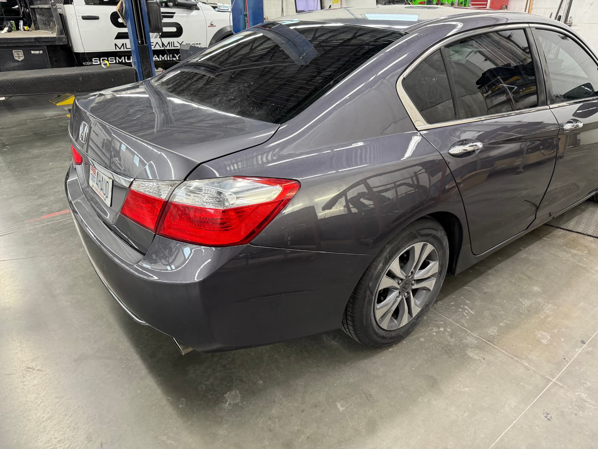 Gray sedan with a clean, color-matched bumper finish after repair at JNG